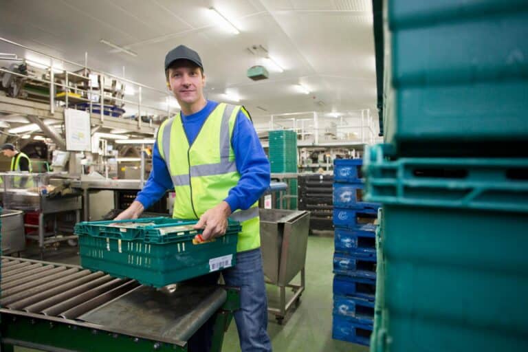 portrait-of-a-worker-lifting-a-tray-of-packaged-po-2026-01-11-09-40-04-utc